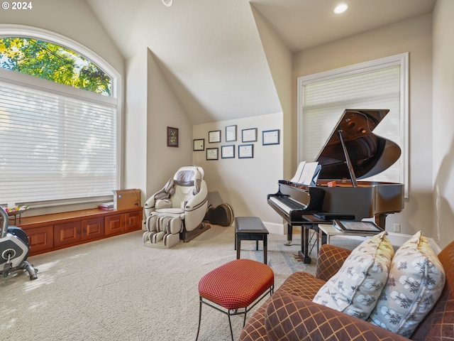 sitting room with carpet floors and vaulted ceiling