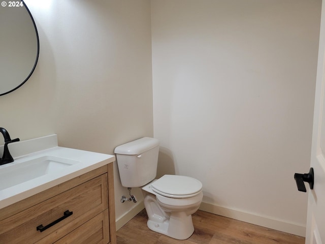 80 S 21st St, Saint Helens, OR 97051 - bathroom featuring wood finished floors, toilet, baseboards, and vanity