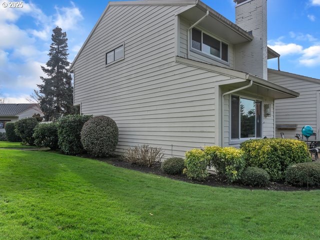 view of side of property with a lawn