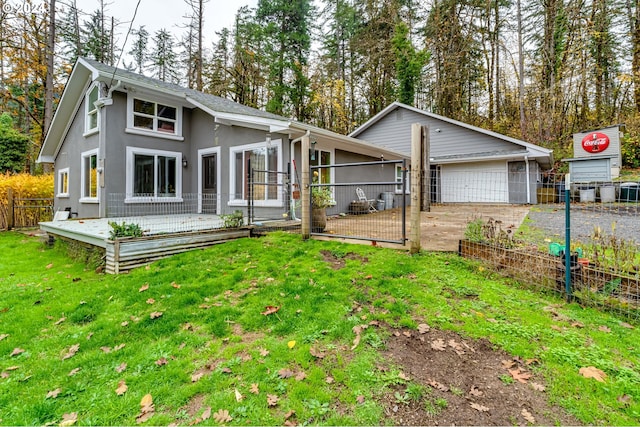 back of property featuring a lawn and a garage