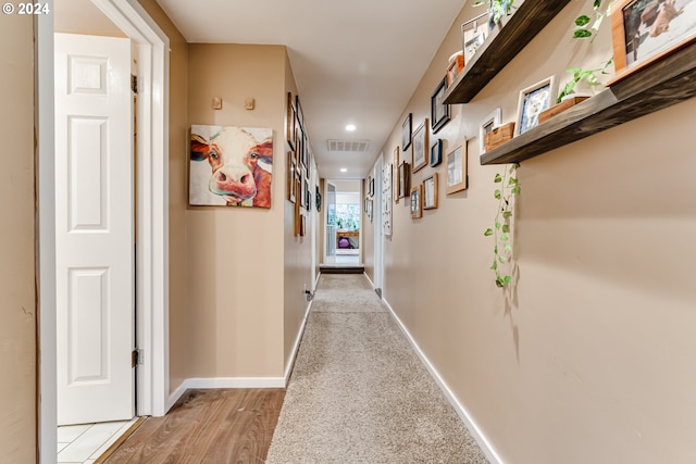 hallway with light hardwood / wood-style flooring