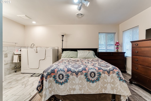 bedroom with light hardwood / wood-style flooring