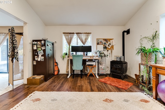 office space with a wood stove, lofted ceiling, and dark hardwood / wood-style floors