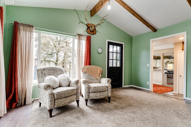 sitting room featuring carpet flooring, lofted ceiling with beams, and a wealth of natural light