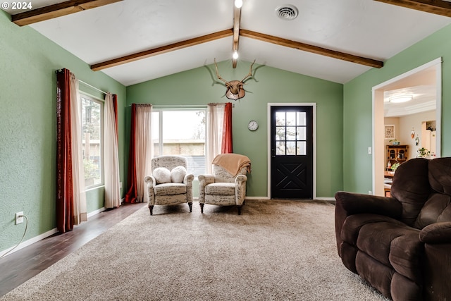 sitting room with wood-type flooring, lofted ceiling with beams, and plenty of natural light