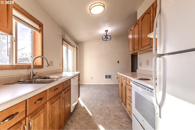 kitchen with lofted ceiling, sink, and white appliances