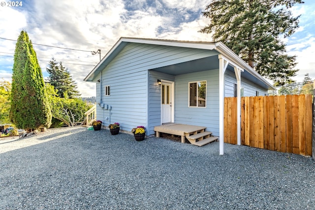 bungalow-style house with fence