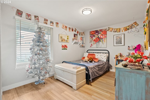 bedroom with hardwood / wood-style flooring