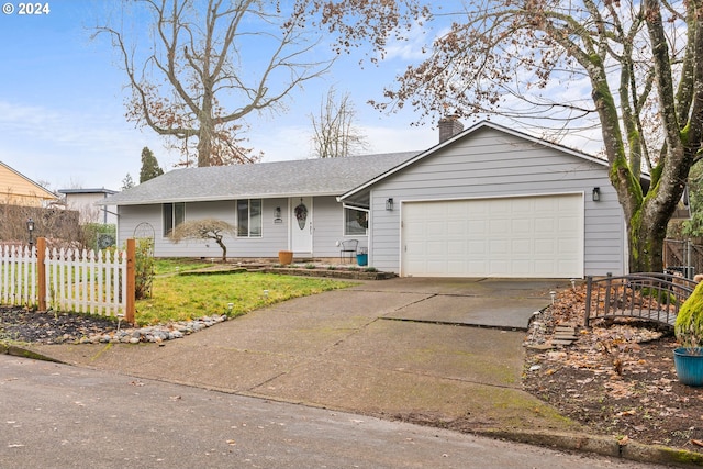 single story home featuring a garage and a front yard