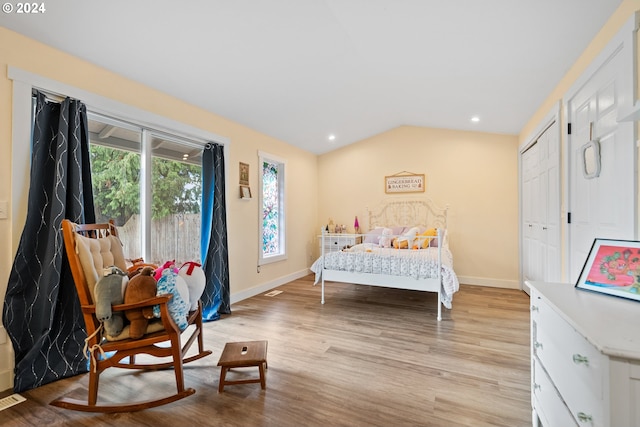 bedroom featuring vaulted ceiling and light wood-type flooring