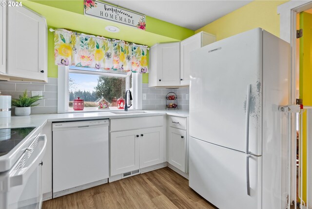 kitchen featuring white cabinets, decorative backsplash, white appliances, and sink