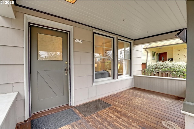 view of exterior entry with a porch