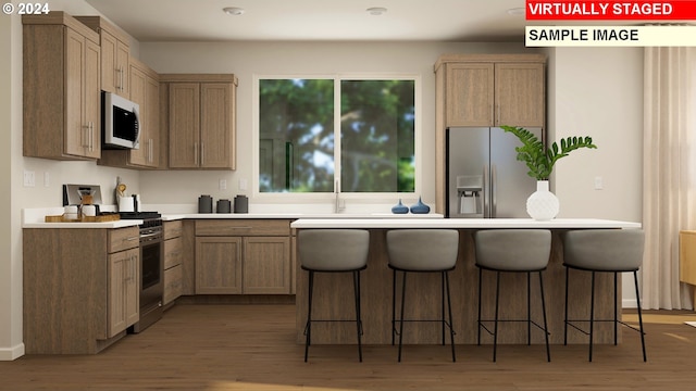 kitchen featuring a breakfast bar, stainless steel appliances, and light hardwood / wood-style flooring