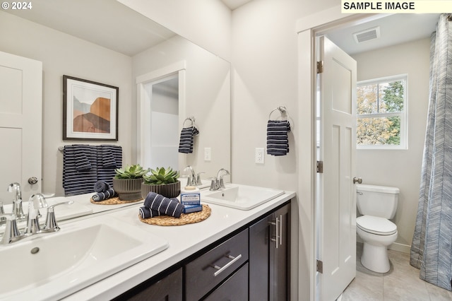 bathroom with tile patterned floors, vanity, and toilet