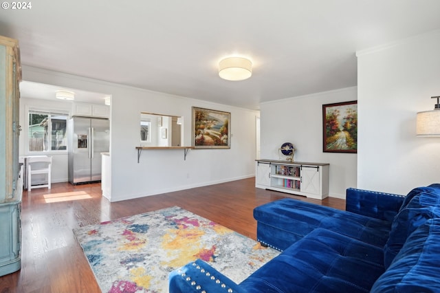 living room featuring ornamental molding and dark wood-type flooring