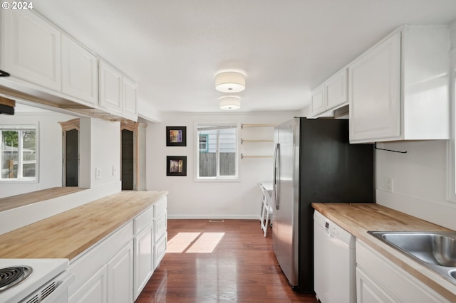 kitchen with white cabinetry, butcher block counters, dark wood-type flooring, and plenty of natural light