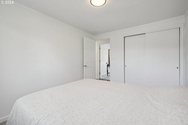 bedroom featuring a closet and ornamental molding