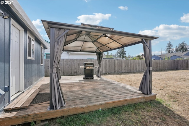 wooden terrace with a grill and a gazebo