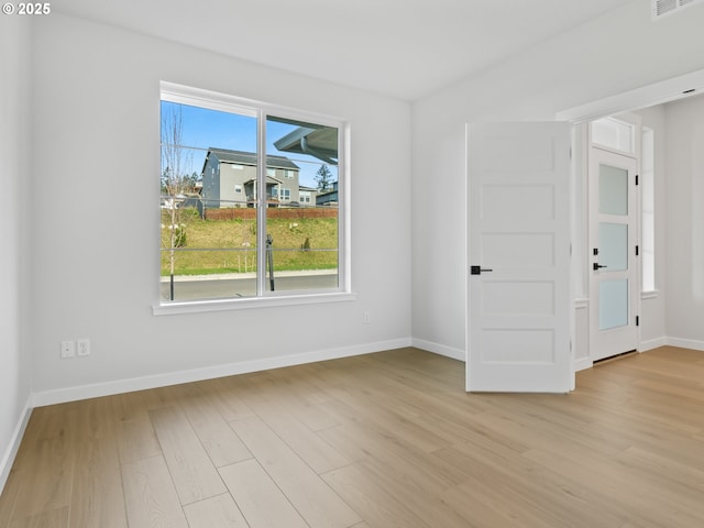 spare room featuring light hardwood / wood-style floors