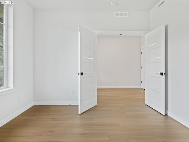 spare room with light hardwood / wood-style floors