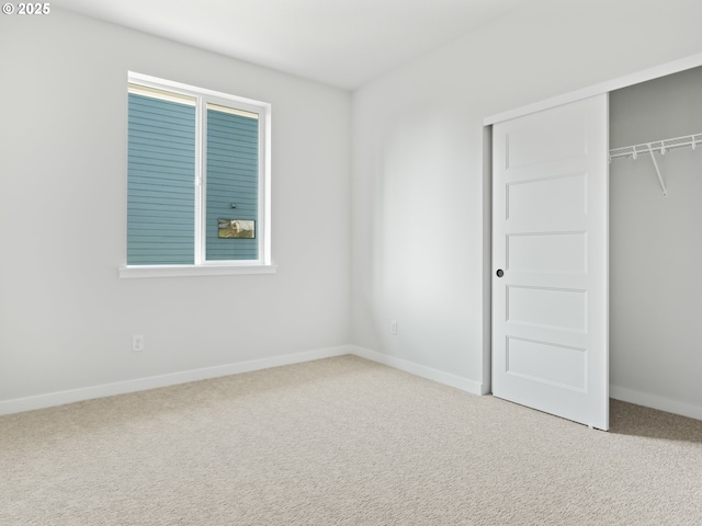 unfurnished bedroom with carpet floors and a closet