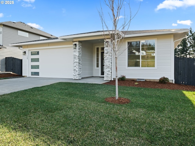 view of front of house featuring a garage and a front lawn