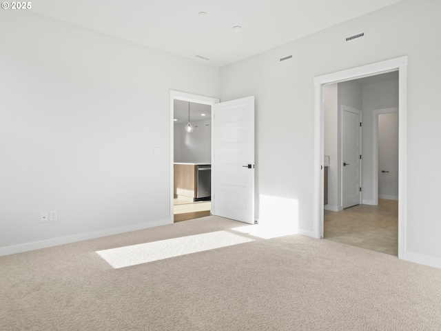 unfurnished bedroom with light colored carpet