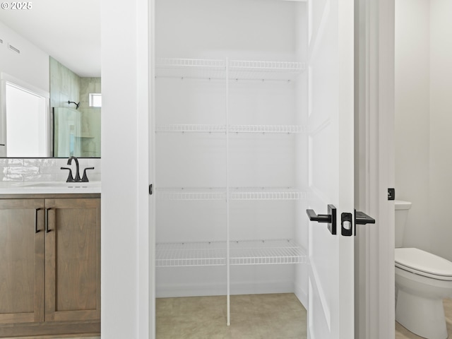 bathroom featuring toilet and vanity