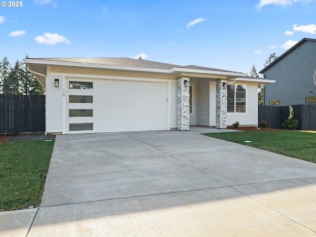 prairie-style house featuring a front lawn and a garage