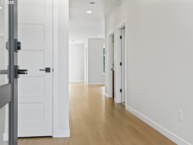 corridor featuring light hardwood / wood-style floors