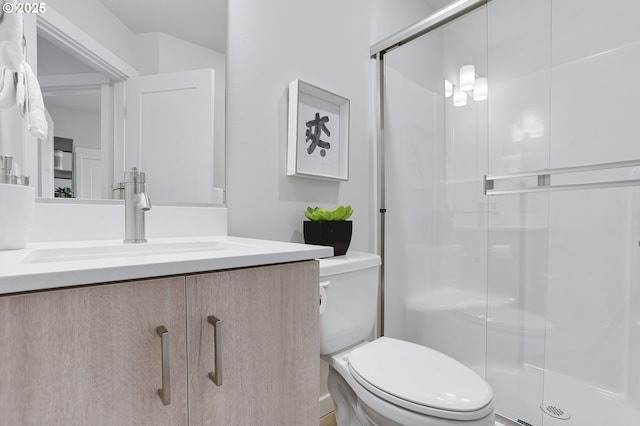 bathroom featuring walk in shower, vanity, and toilet