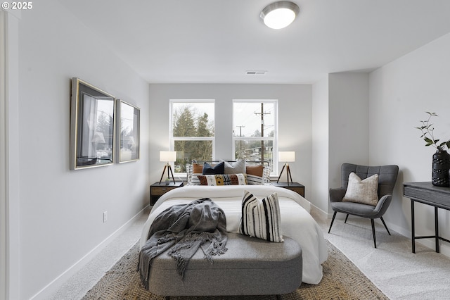 bedroom with light carpet and multiple closets