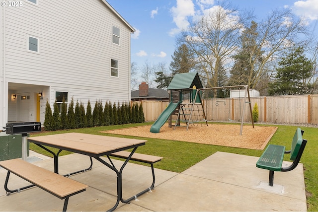 view of jungle gym featuring a patio and a yard