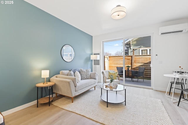 living room featuring a wall mounted AC and light wood-type flooring