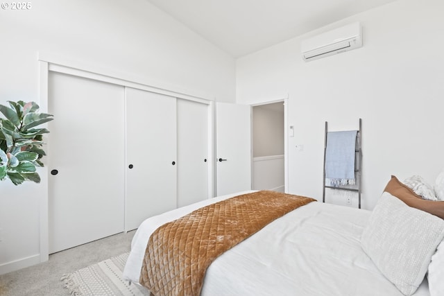 bedroom with a closet, a wall mounted AC, vaulted ceiling, and light carpet