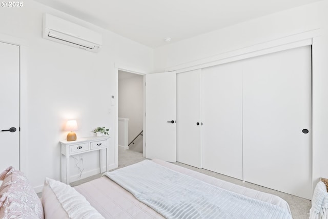 bedroom with a wall mounted AC and a closet