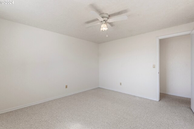 unfurnished room featuring ceiling fan, carpet floors, and a textured ceiling