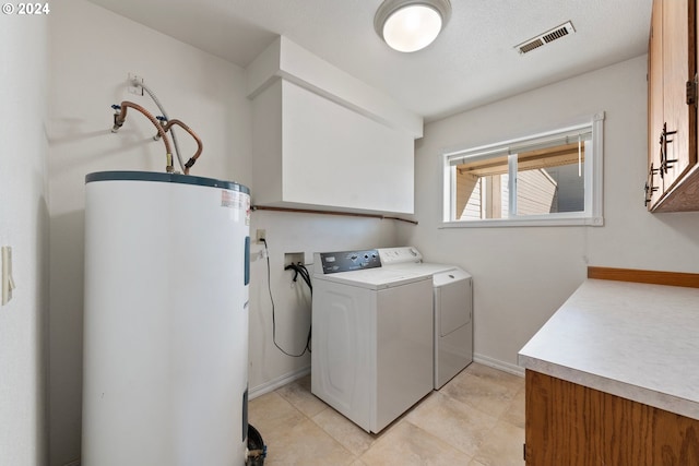 washroom with cabinets, separate washer and dryer, water heater, and a textured ceiling