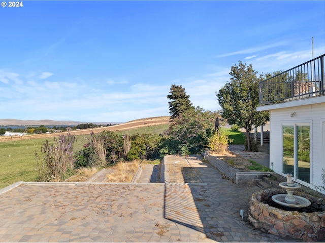 view of patio featuring a balcony