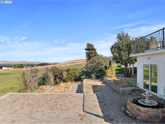 view of yard with a balcony and a patio area