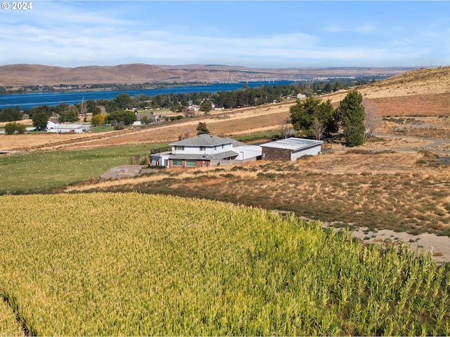 drone / aerial view featuring a water and mountain view