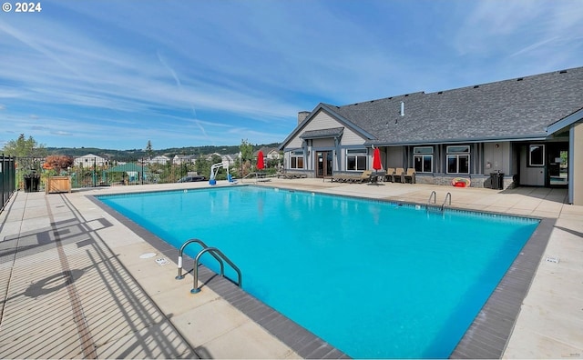 view of pool featuring a patio and a water slide