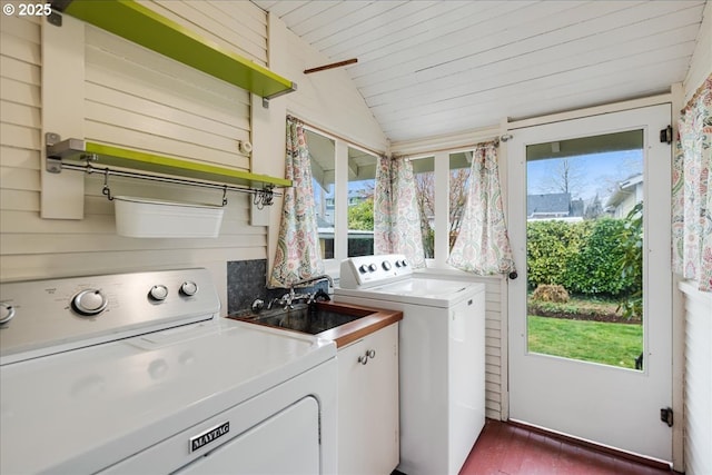 washroom featuring a wealth of natural light, separate washer and dryer, a sink, and cabinet space