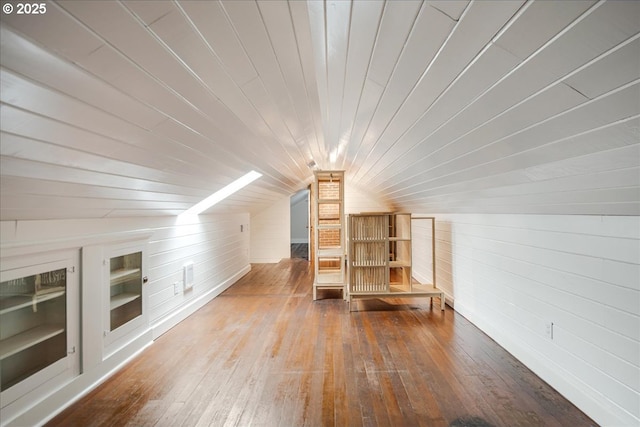 bonus room with built in shelves, wooden ceiling, wood walls, and hardwood / wood-style flooring