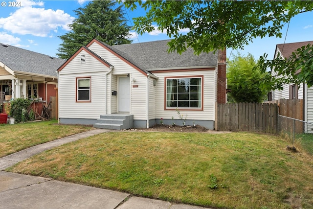 bungalow-style home with a front yard