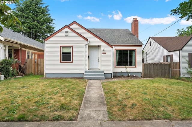 bungalow-style house with a front lawn