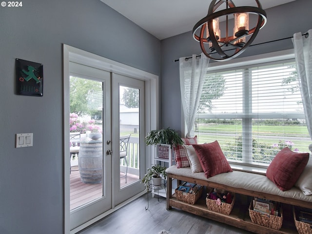 doorway featuring wood-type flooring, an inviting chandelier, and french doors