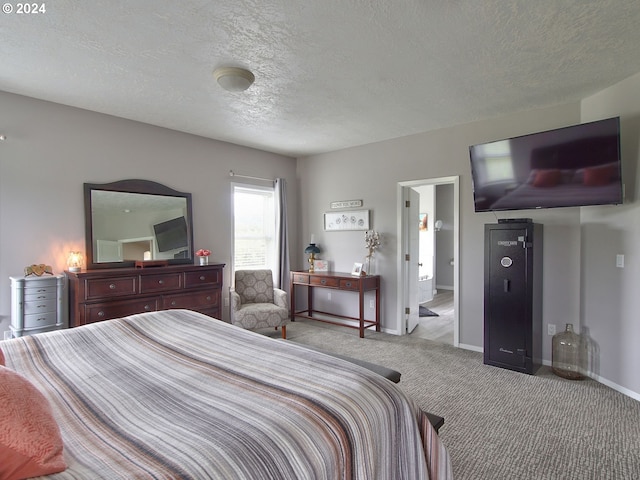 bedroom featuring light carpet and a textured ceiling