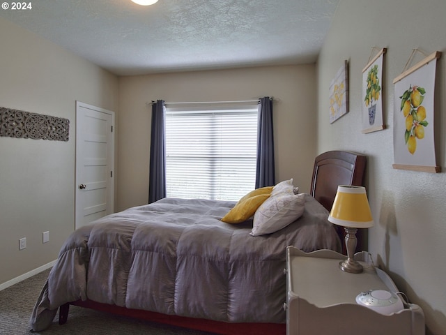 bedroom with carpet floors and a textured ceiling