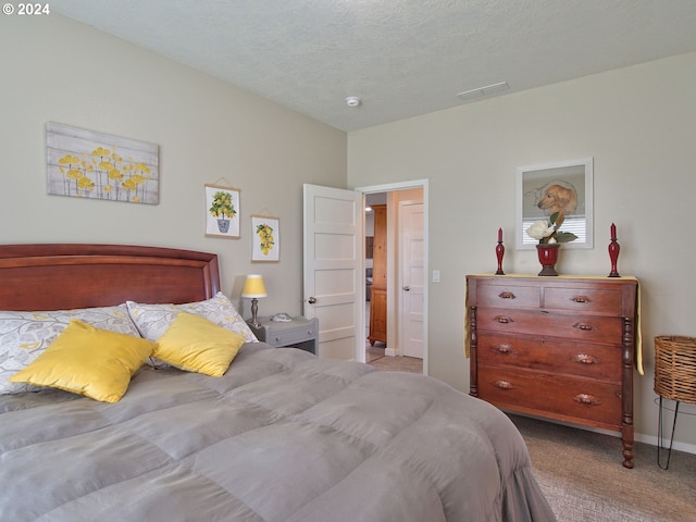 carpeted bedroom featuring a textured ceiling